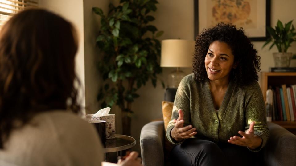 How Long Is an Intensive Outpatient Program hero image of someone in therapy.