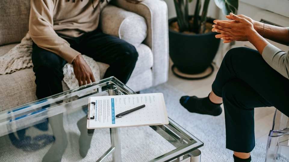 What Is a Partial Hospitalization Program for Substance Abuse hero image of a person in therapy.